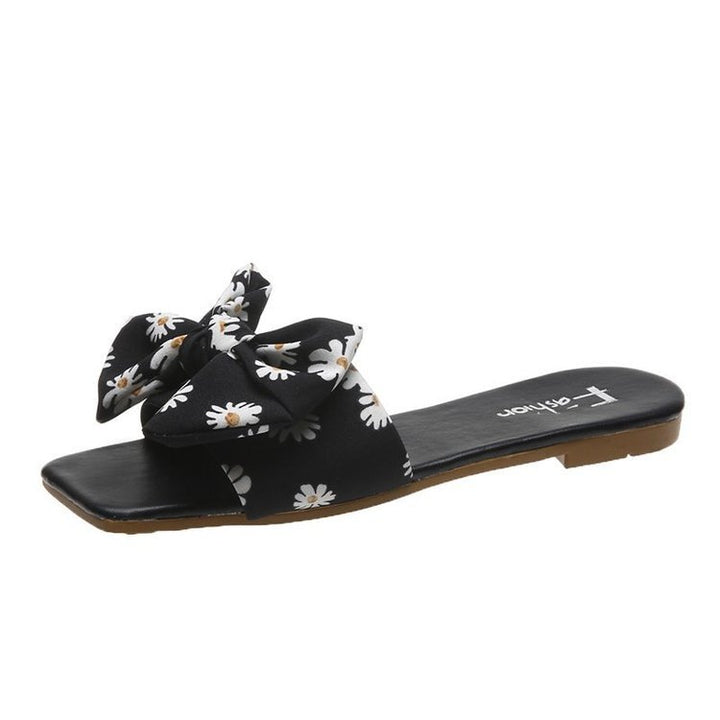 Dame fashionable slippers med legende blomsterdesign og elegante sløjfer Stilla