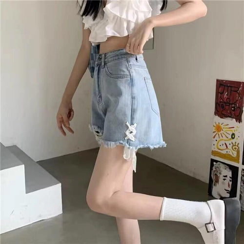 Dame denim shorts med trendy ødelagte detaljer og håndlavede accenter