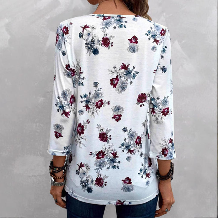 Damebluse med florale accenter og knapper Stilla
