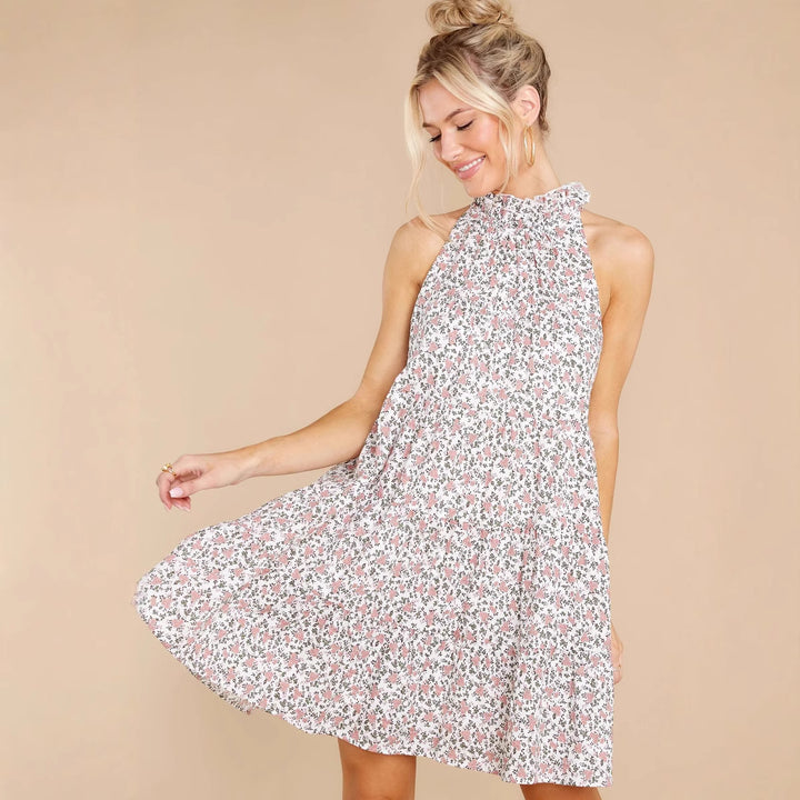 Women's halter dress with playful floral design and ruffle details
