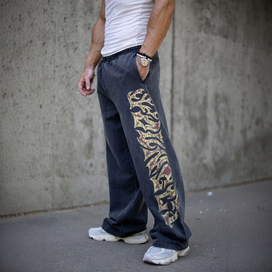 Herrer nan brede joggingbukser med elastisk talje, sidelommer og detaljeret kranium- og rosenmotiv Skovae