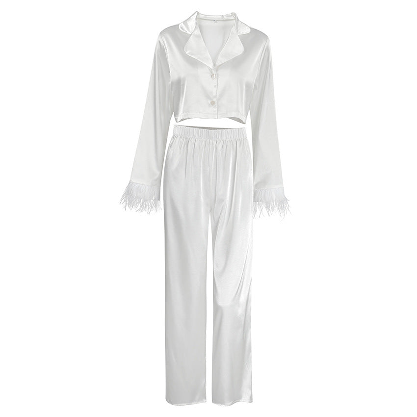 Dame Elegant cropped top og løstsiddende bukser med fjerdetaljer Stilla
