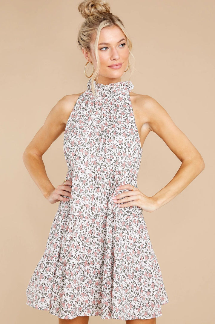 Women's halter dress with playful floral design and ruffle details