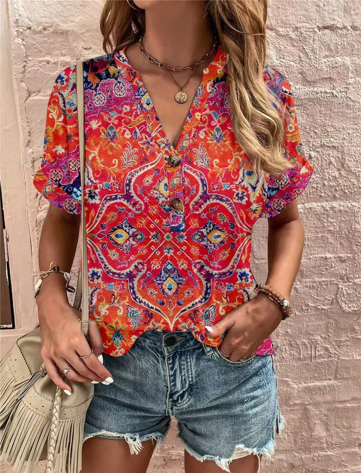 Damebluse med blomsterdesign og knaplukning Stilla