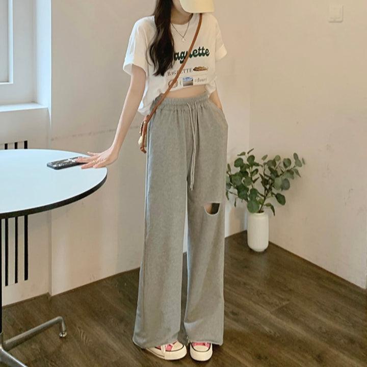 Kvinders casual brede sweatpants med fashionable udskæring og elastisk talje.