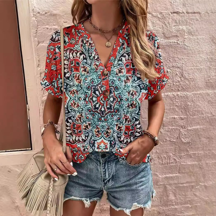 Damebluse med blomsterdesign og knaplukning Stilla
