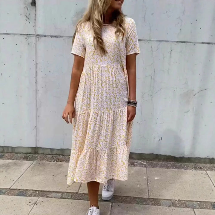 Kvinde i luftig lagdelt maxi-kjole i boho-babydoll-stil med rynket underbust og korte ærmer Skovae