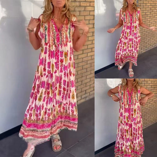 Dame i flydende maxikjole i boho-stil med V-udskæring, stribet nederdel og broderet pas Skovae