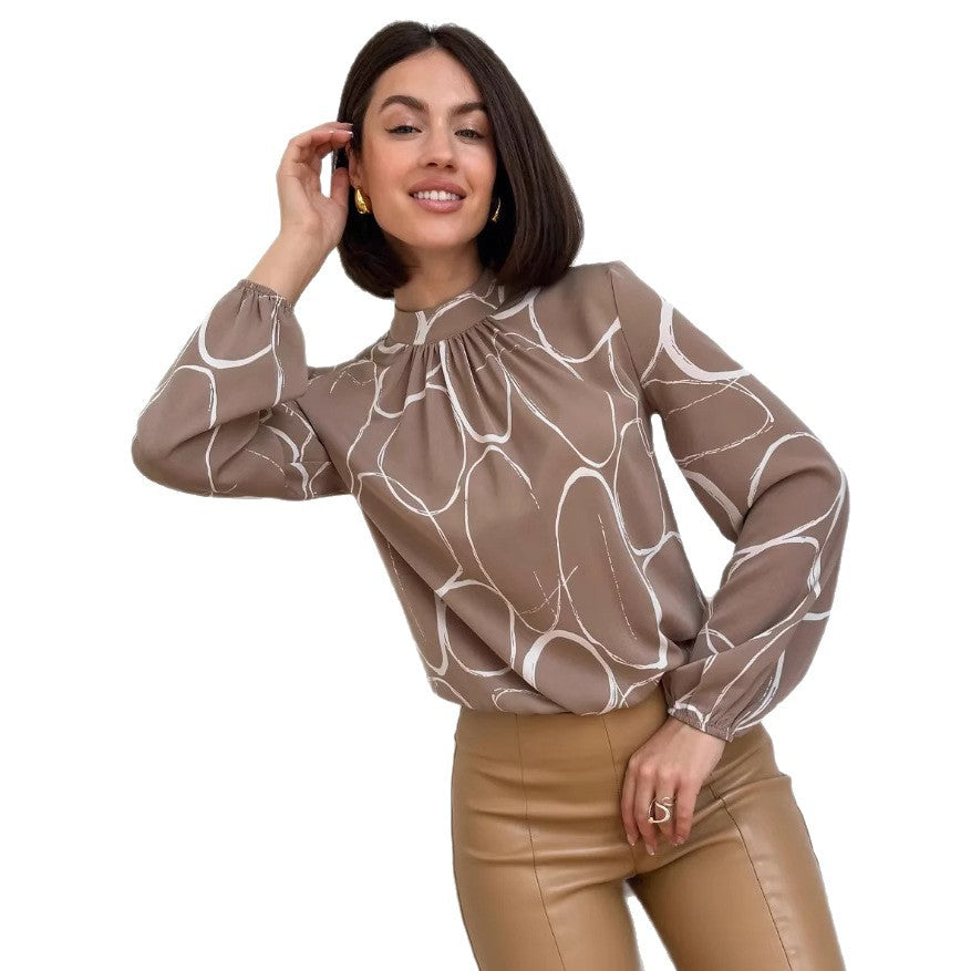 Damebluse med elegant blomsterdesign og bredt ærme Stilla