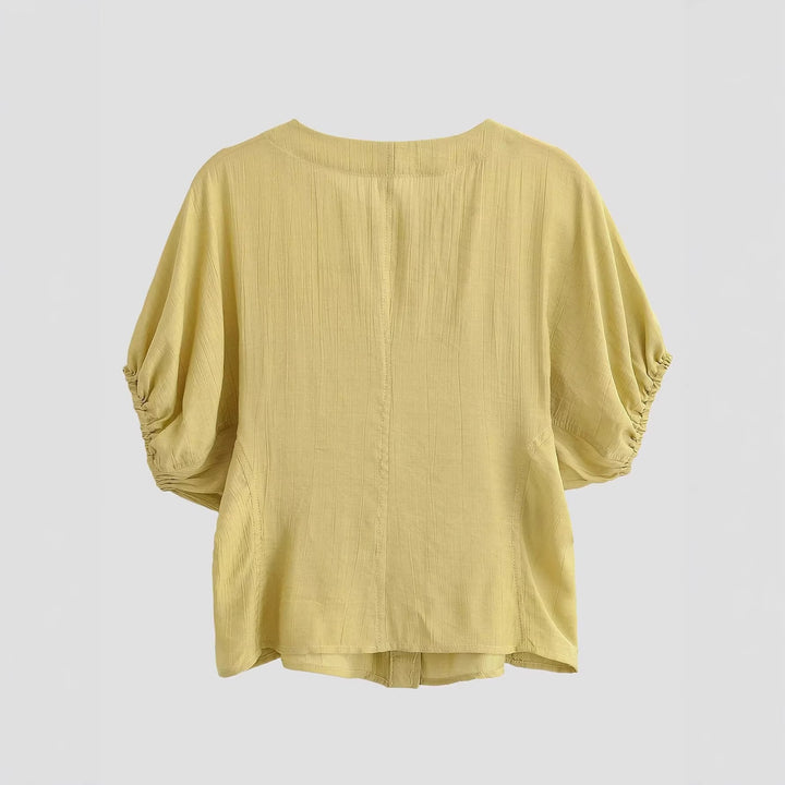 Damebluse med puffærmer og dekorative knapper Skovae