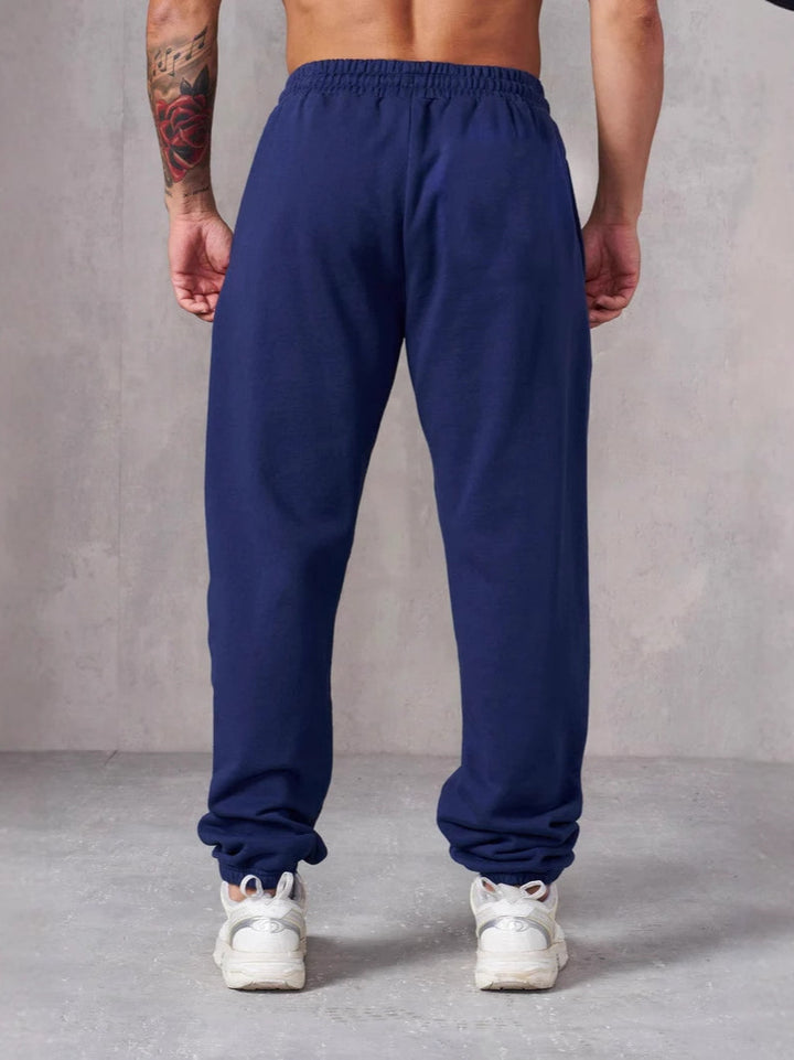 Herre Baggy Joggingbukser med Elastisk Talje og Sidetasker Skovae