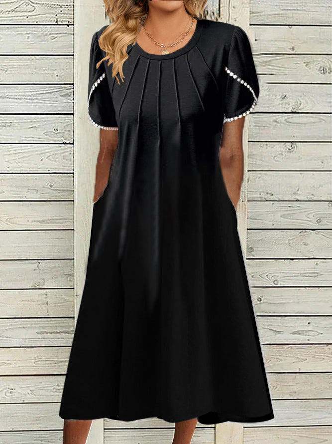 Dame fritidskjole med elegante draperinger og praktiske lommer Stilla