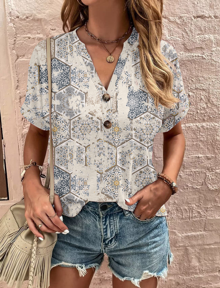 Damebluse med blomsterdesign og knaplukning Stilla