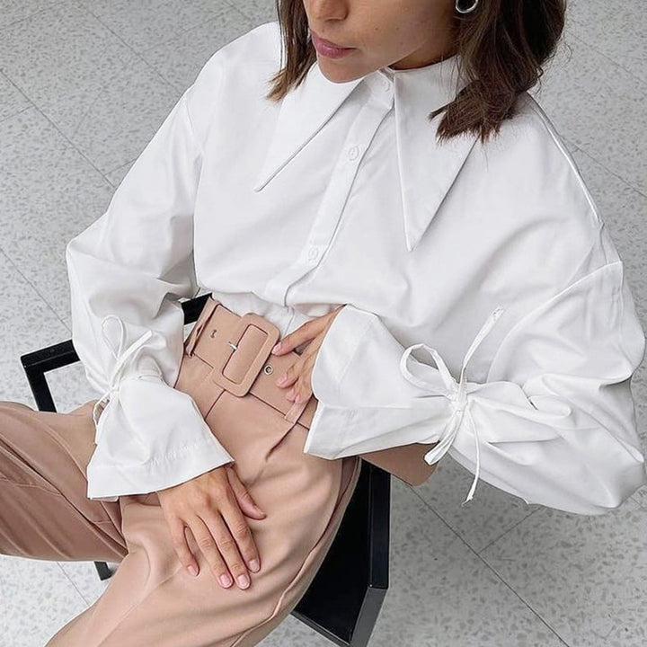 Damebluse med raffinerede knudedetaljer og elegant krave Stilla