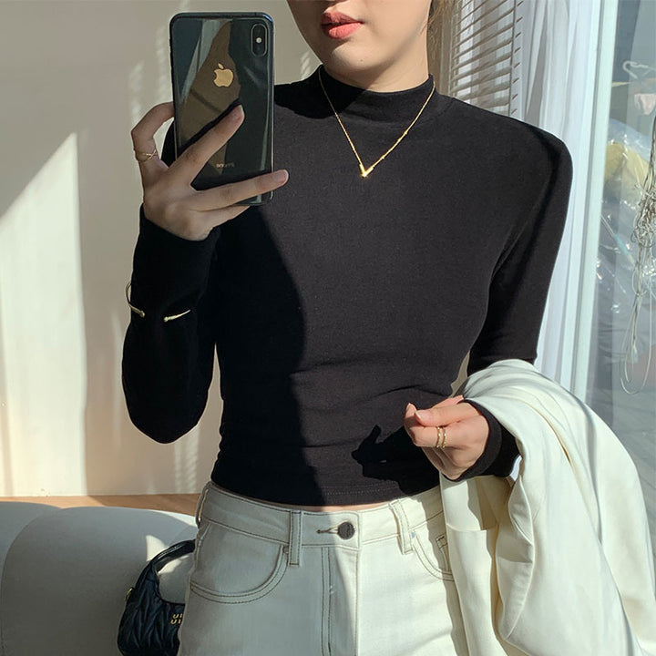 Kvinders langærmet crop top med høj krave og tætsiddende pasform