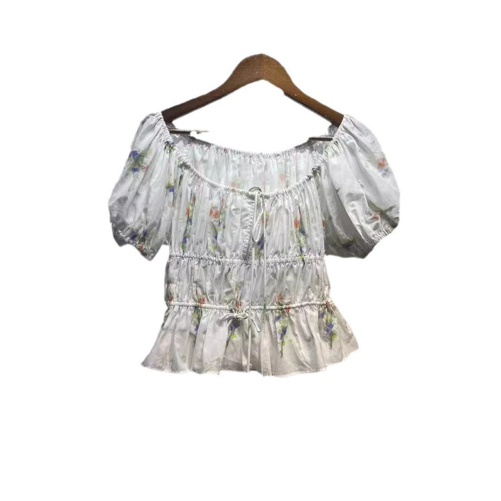 Damebluse med innovativt flæsedesign og blomstret tryk Stilla