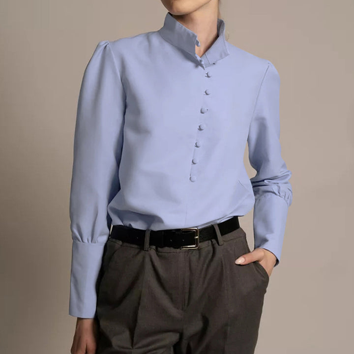 Damebluse med høj ståkrave og elegante pufærmer Stilla