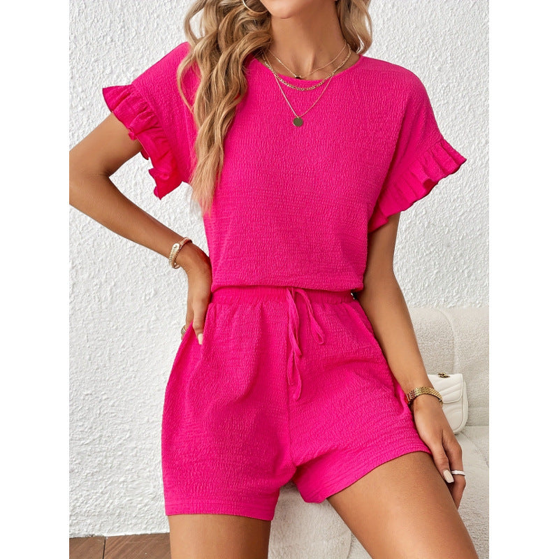 Dame kortærmet jumpsuit med flæse detaljer og bindebælte Skovae