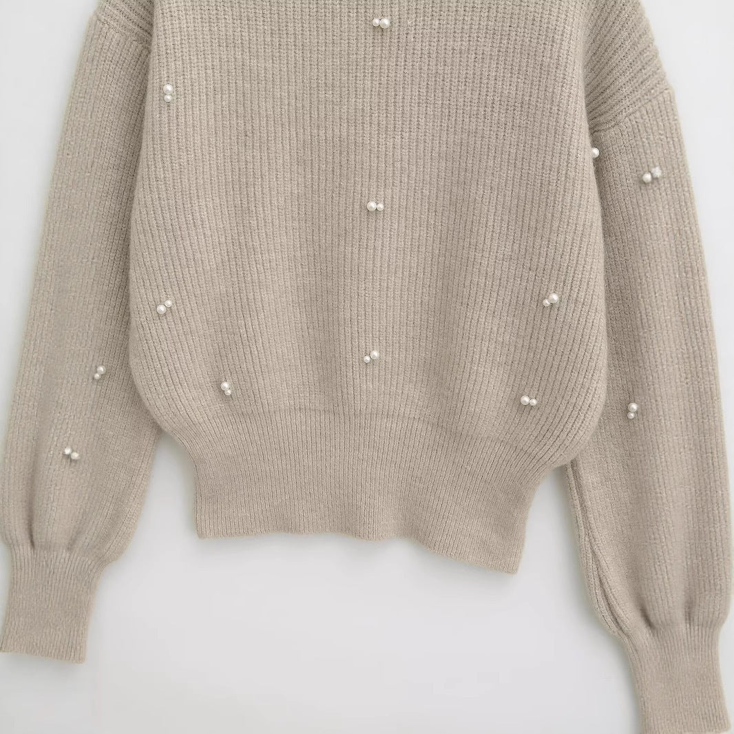 Dame modisk strikpullover med elegante perledetaljer Stilla