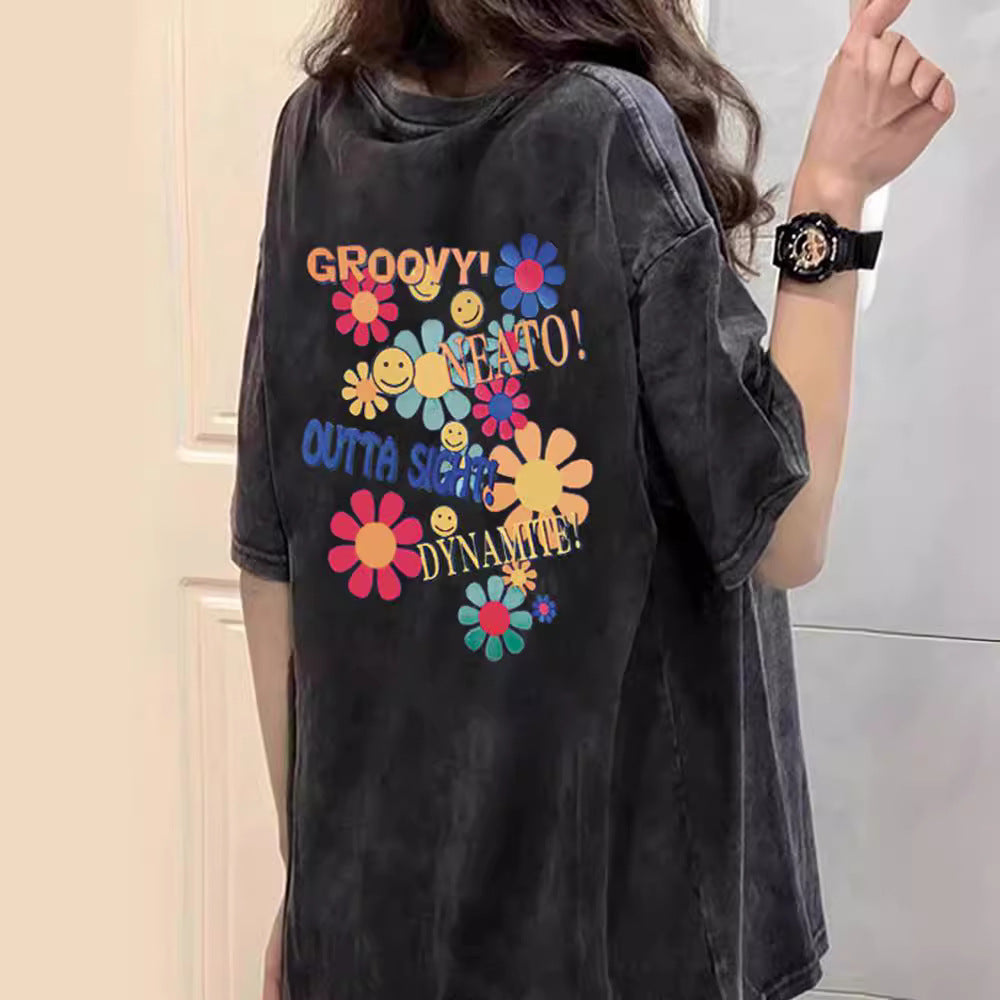 Dame T-shirt med kreativt blomster- og smiley-design Stilla