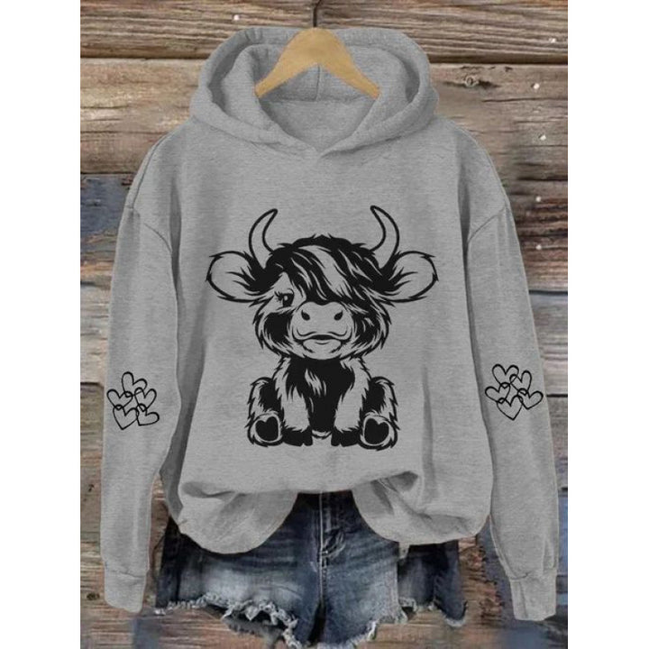 Kvindernes hætte sweatshirt med charmerende kvægmotiv og praktiske kængurulommer Skovae