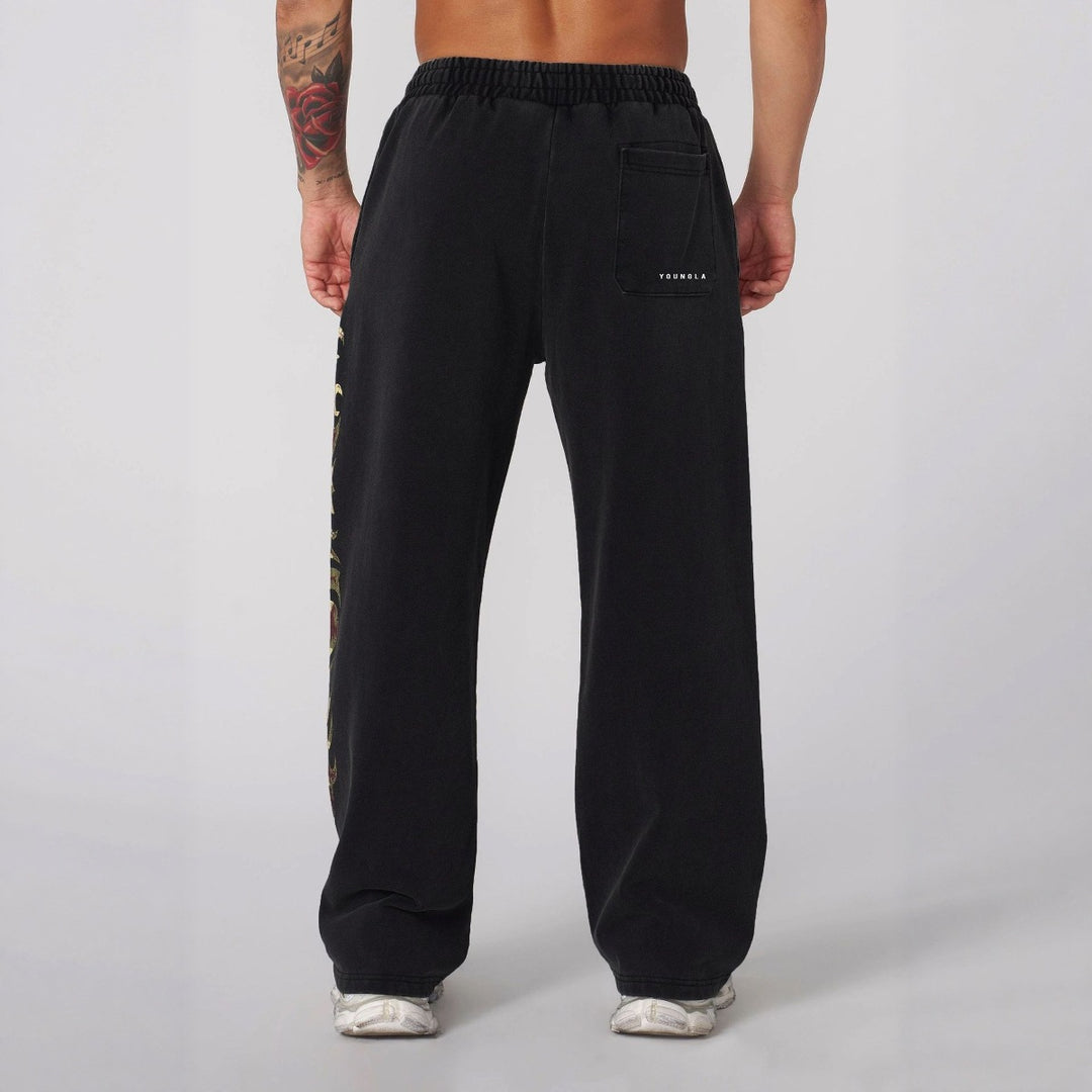 Herrer nan brede joggingbukser med elastisk talje, sidelommer og detaljeret kranium- og rosenmotiv Skovae