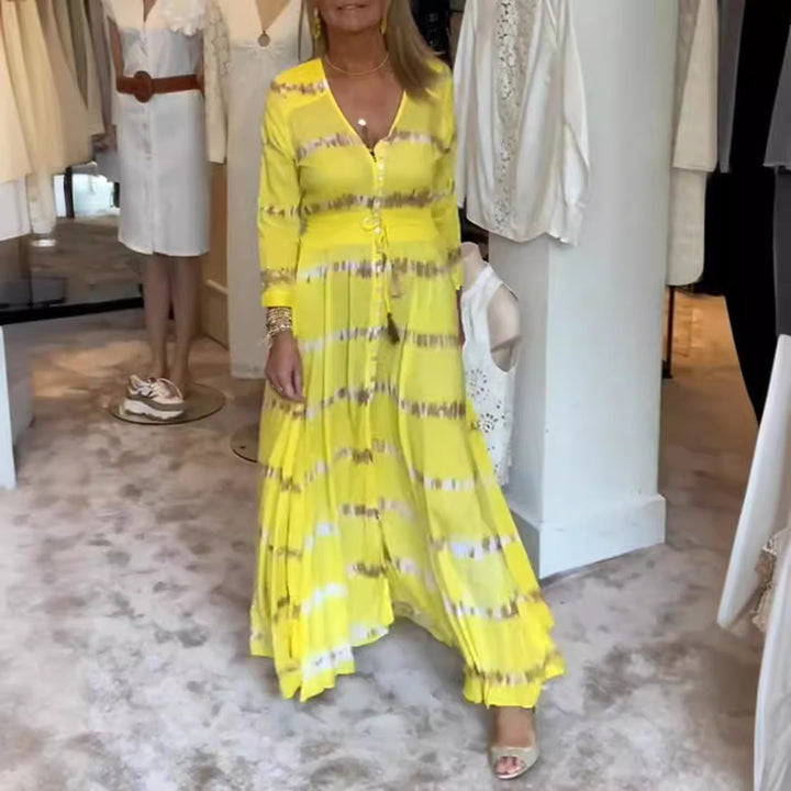 Dame nan flydende Maxikjole med V-udskæring, gennemgående knapliste, taljerende kvastbånd og plisseret nederdel Skovae