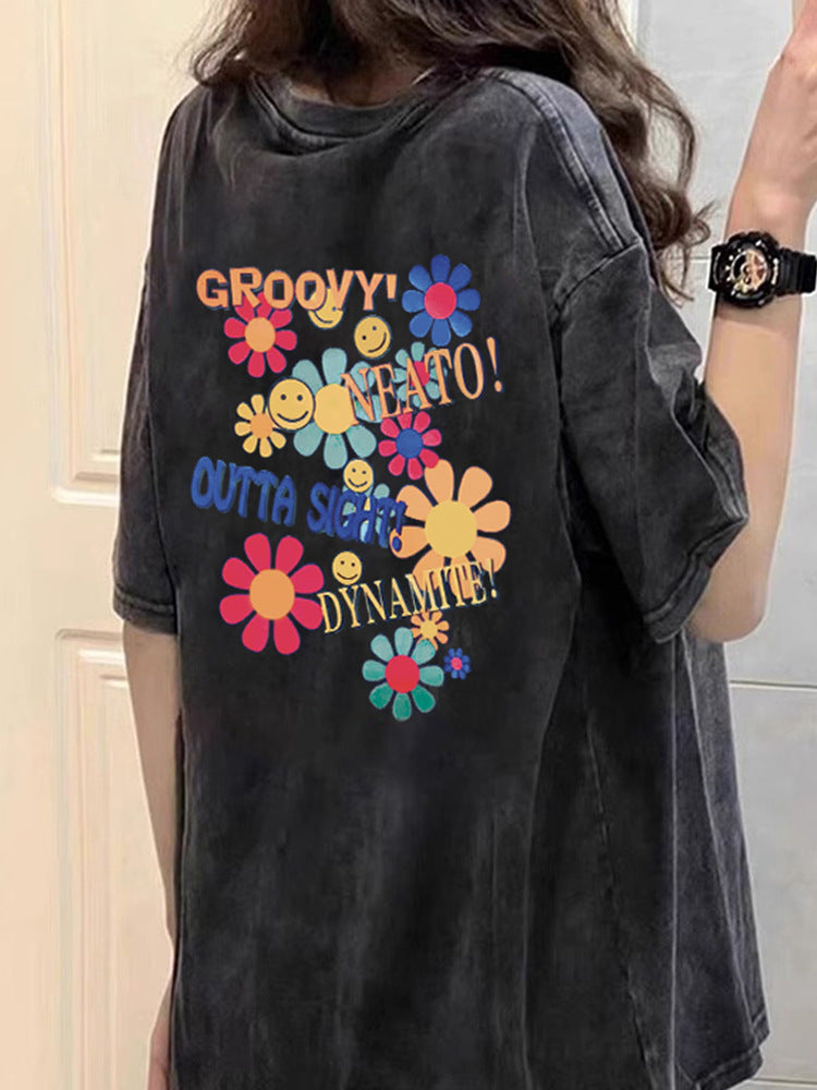 Dame T-shirt med kreativt blomster- og smiley-design Stilla