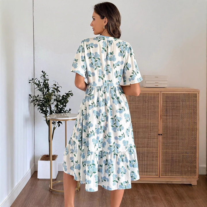 Dame midikjole med friske blomsterprint og voluminøs nederdel Skovae