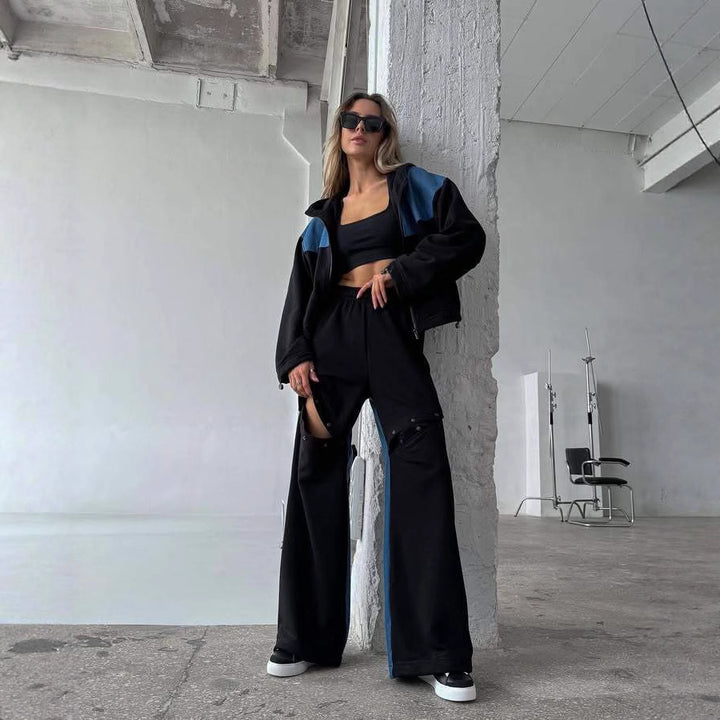 Kvinders fashionable casual outfit med sporty jakke og kreativt udskårne bukser Skovae