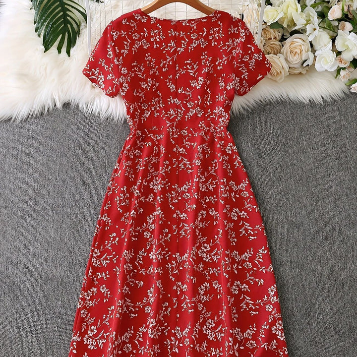 Dame knapkjole med blomsterdesign og svajende kant Stilla
