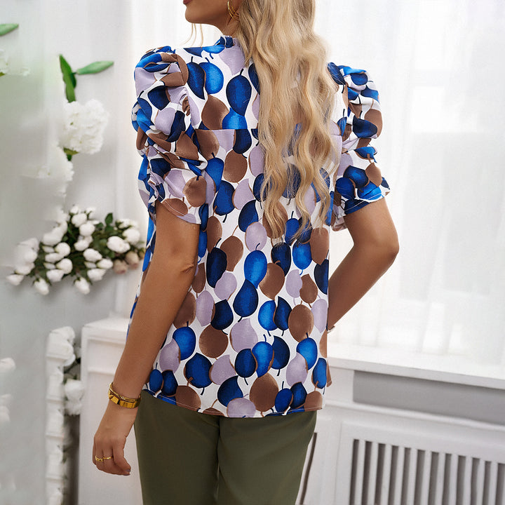 Damebluse med luftige puffærmer og blomsterdesign Stilla