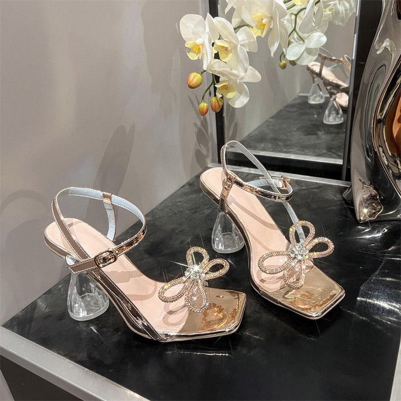 Dame sandaler med glitrende sløjfedesign og gennemsigtig hæl Stilla