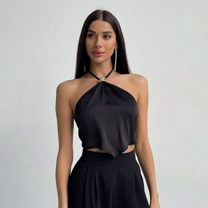 Dames elegant halterneck top med shiny stof og dekorativ knude Stilla