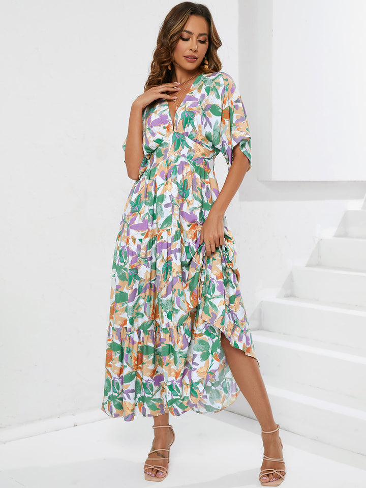 Dame maxikjole med blomsterdesign og buet kant Stilla