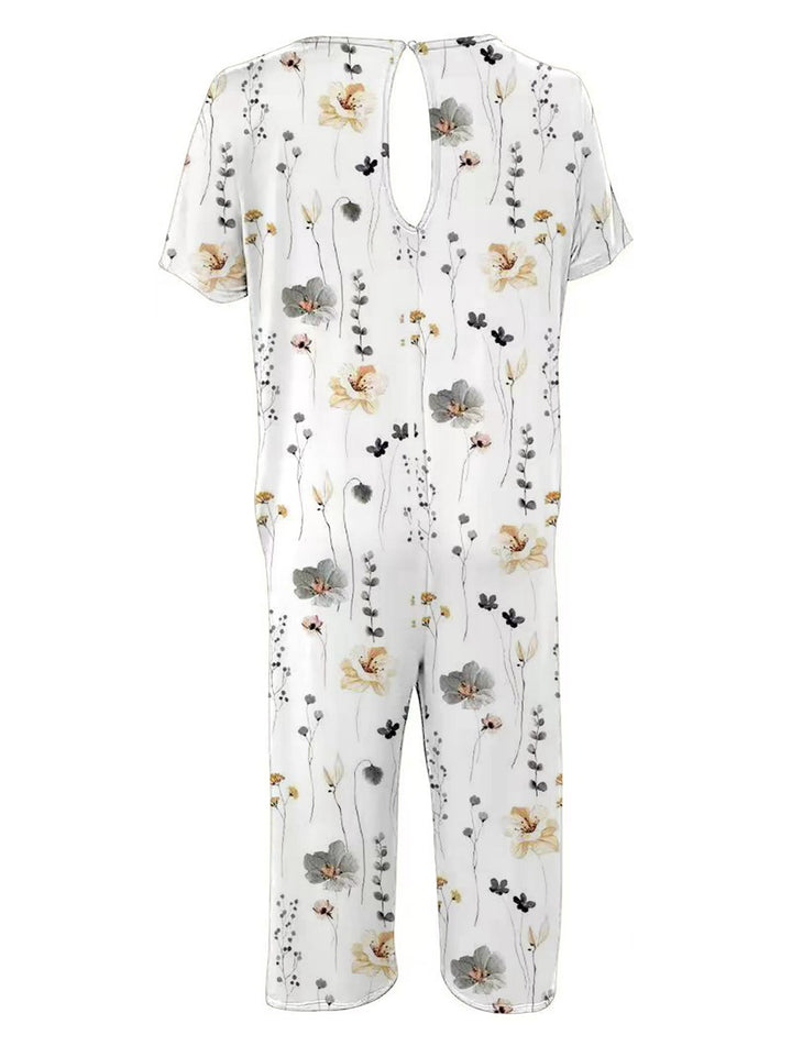 Damer bred blomster-jumpsuit med lommer og bådudskæring Stilla