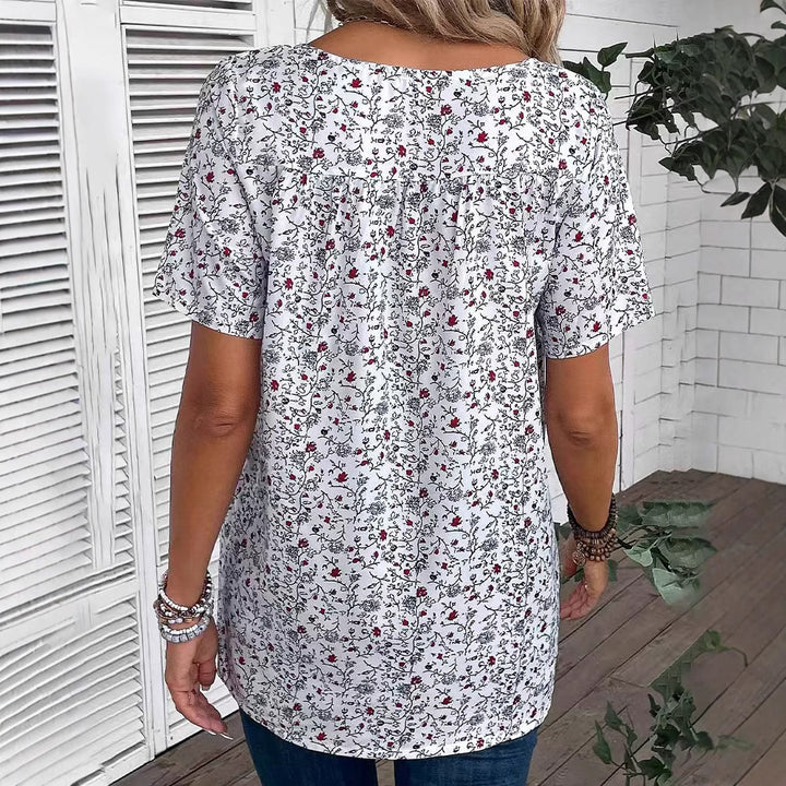 Dame nan afslappet kortærmet tunika-shirt med rund halsudskæring, delikat blomsterprint og dekorative brystfolder Skovae