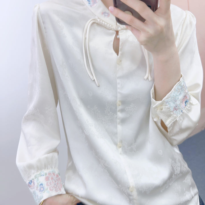 Damebluse med kunstneriske flæser og elegante perle detaljer Stilla