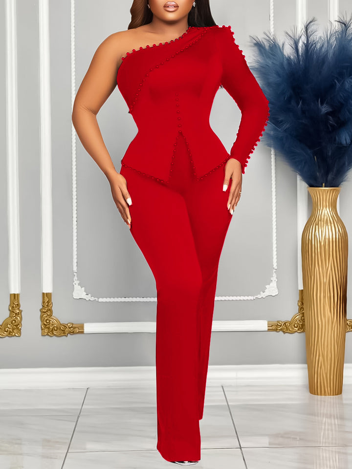 Dame jumpsuit med asymmetrisk design og dekorative elementer Stilla