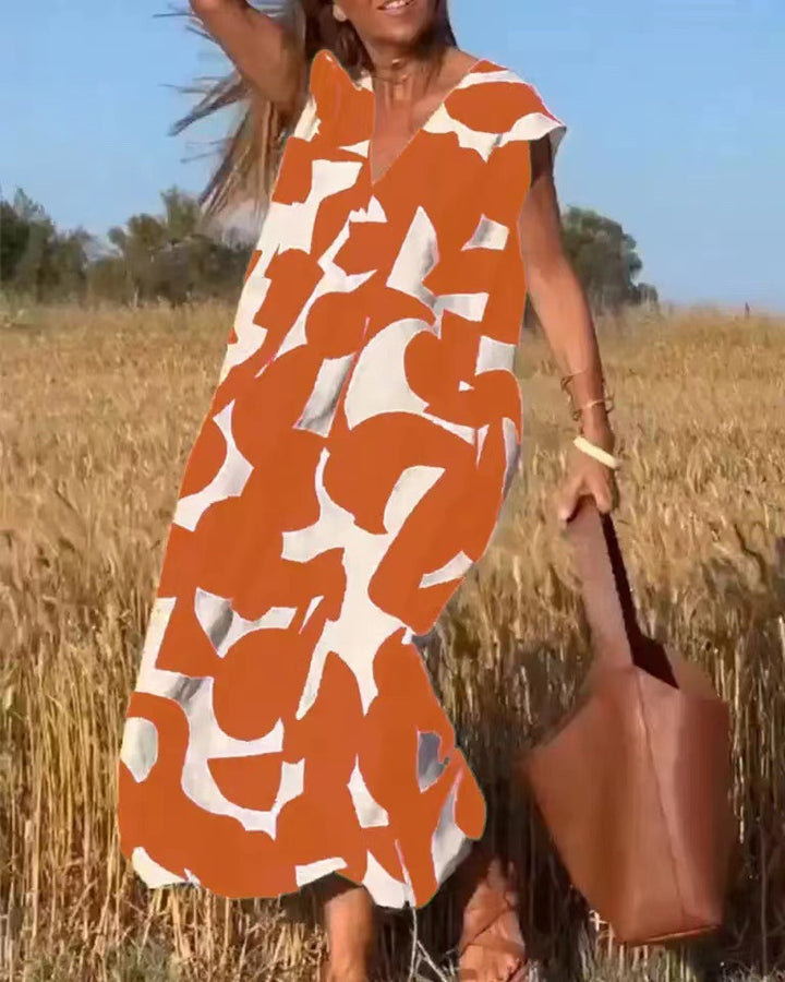Dame Maxikjole med unikt geometrisk print og elegant V-udskæring Stilla