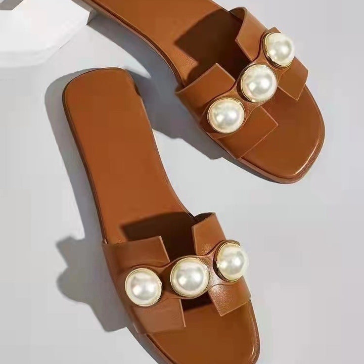 Dame pantoletten med elegant perle-design og moderne rem Stilla