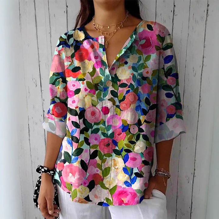 Damebluse med blomsterdesign og knaplukning Stilla