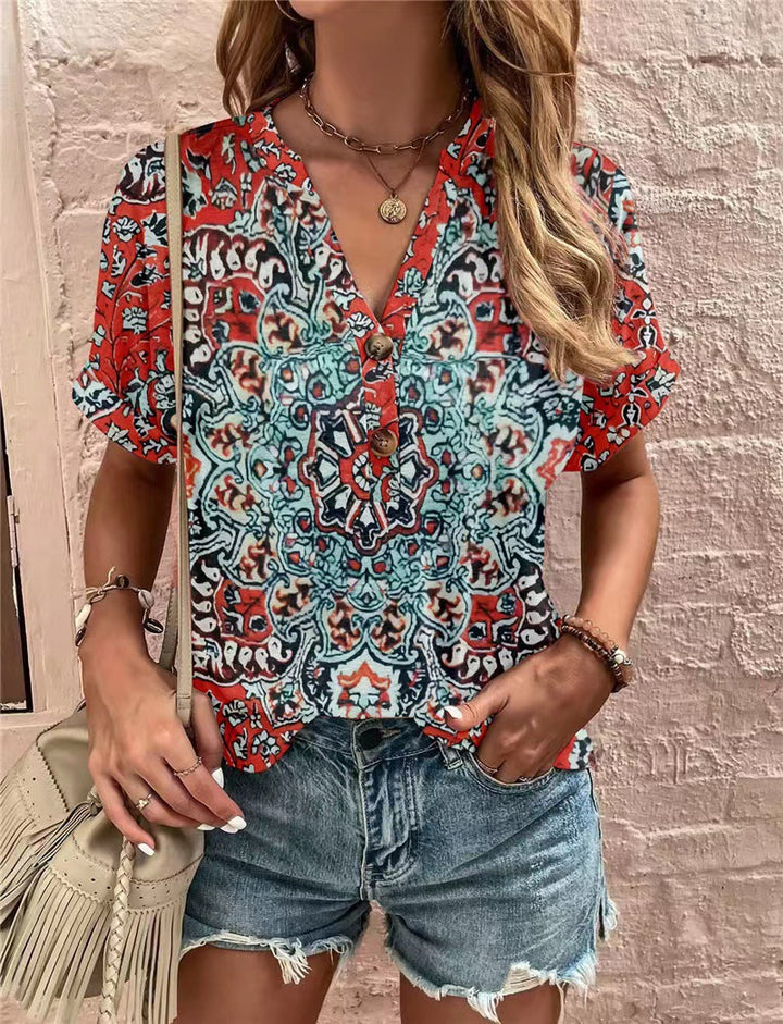 Damebluse med blomsterdesign og knaplukning Stilla