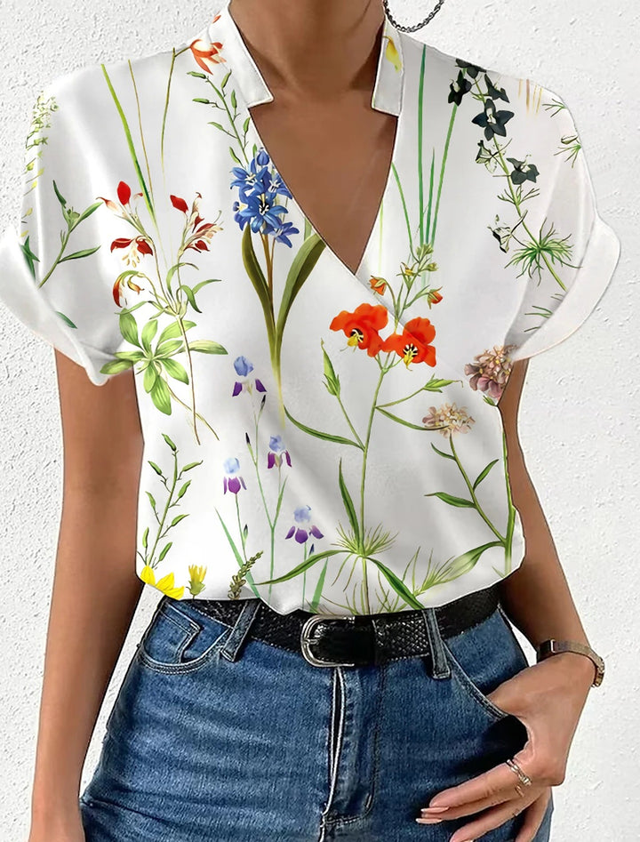 Damebluse med floralt design og moderne V-udskæring Stilla