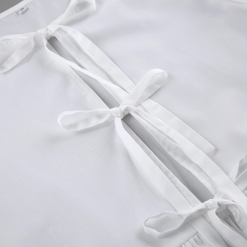 Damebluse med draperinger og dekorative sløjfer Stilla