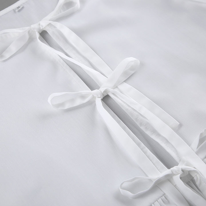 Damebluse med draperinger og dekorative sløjfer Stilla