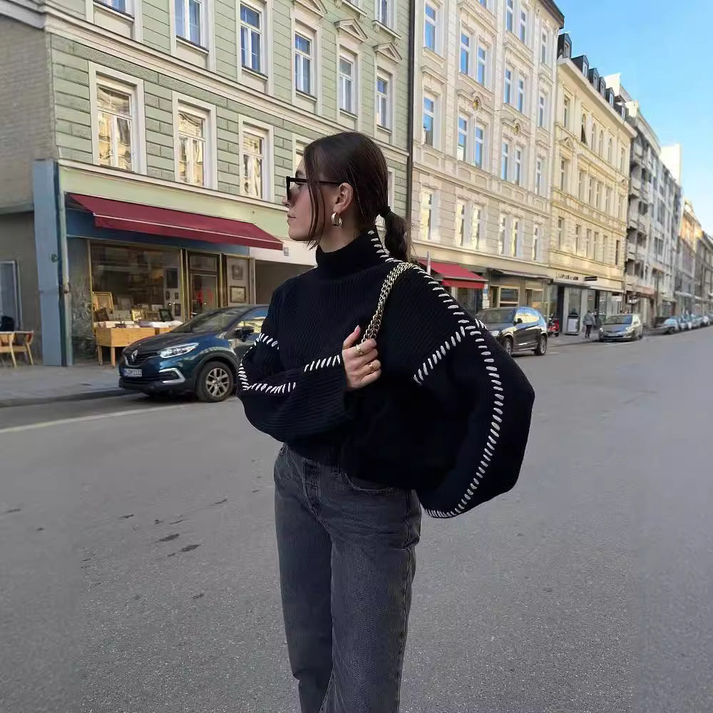 Kvinders chunky striktrøje med høj krave og elegante ærme accenter Stilla