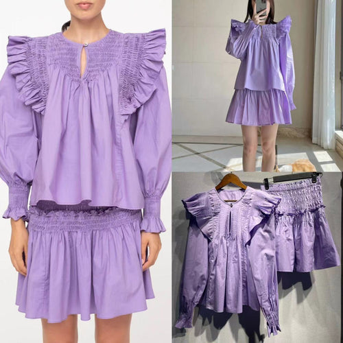 Damebluse med voluminøse flæsedetaljer og særpræget plisséfold Stilla