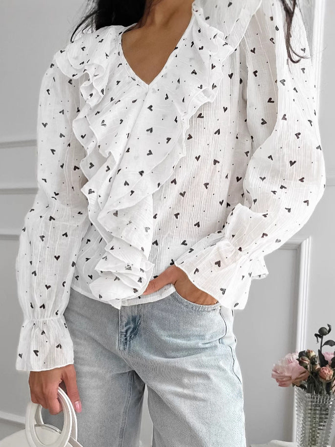 Dame blusende bluse med voluminøse flæser og V-hals Stilla