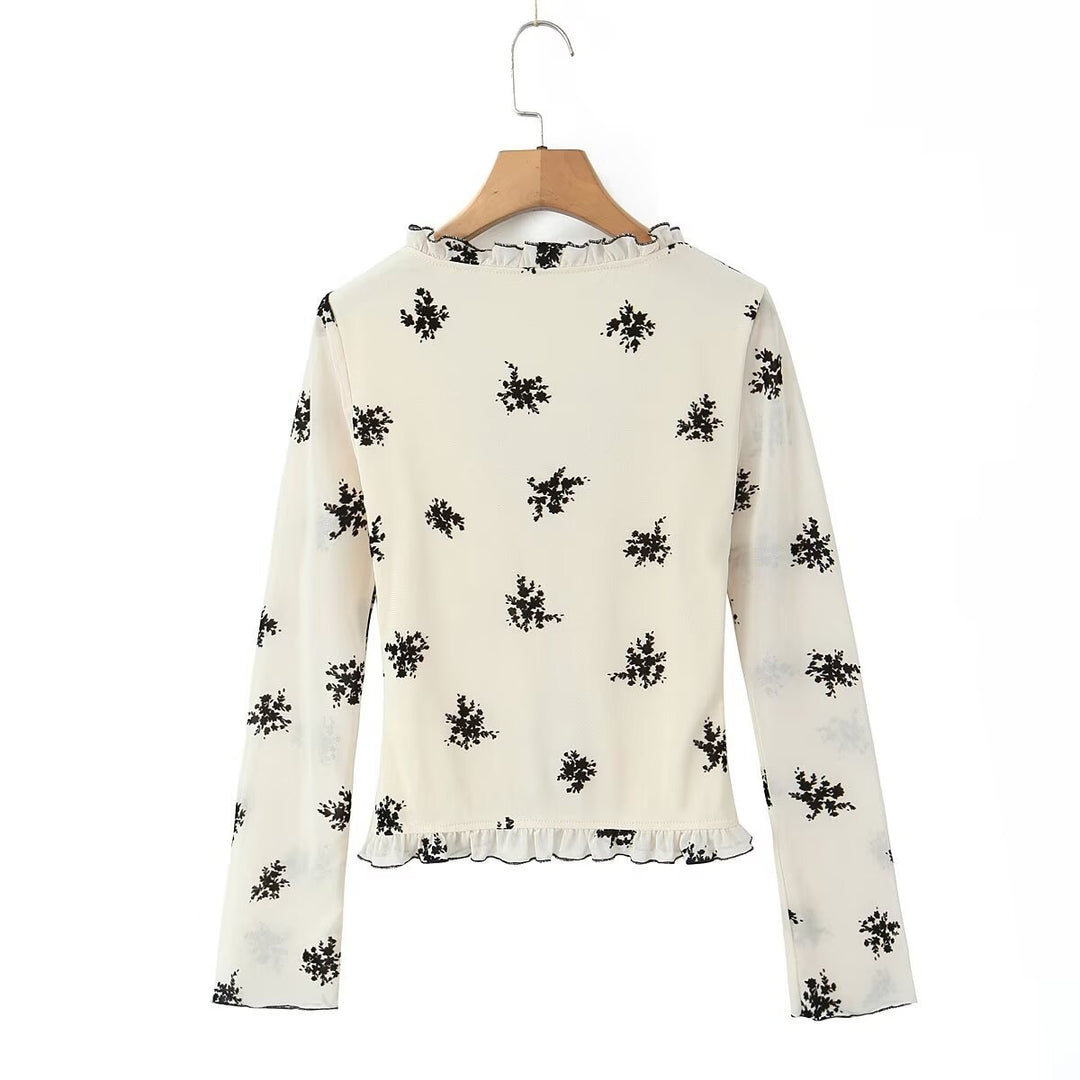 Damebluse med blomstret design og flæsedetaljer Stilla